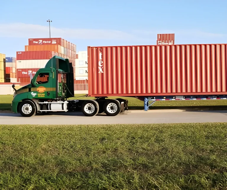 Hermann green tractor hauling a container at the port