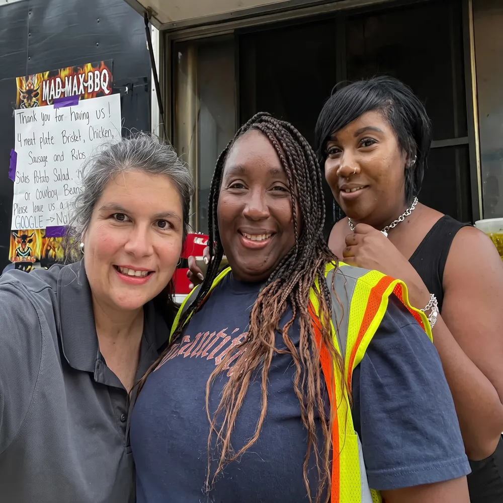 Three Hermann team members smiling at a company barbecue