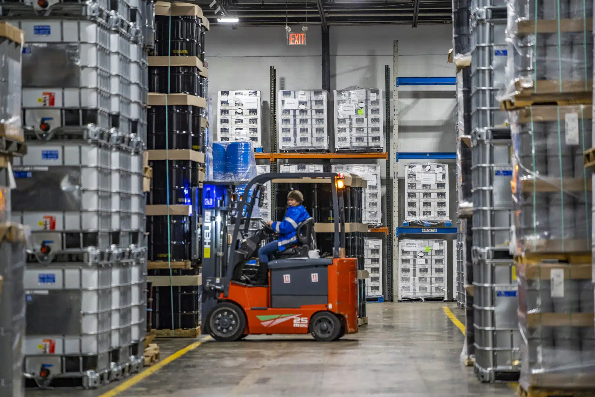 Operator moving product on an electric forklift inside a Hermann warehouse